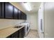 Functional laundry room with cabinets, countertops, sink, and appliances at 21320 N 56Th St # 1085, Phoenix, AZ 85054