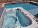 Inviting backyard features a sparkling pool and a relaxing hot tub, perfect for outdoor enjoyment and leisure at 21432 W Minnezona Ave, Buckeye, AZ 85396