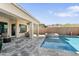This backyard features a covered patio and a sparkling pool perfect for relaxing and entertaining at 21432 W Minnezona Ave, Buckeye, AZ 85396