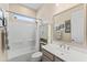 Bathroom showcasing a shower-tub combo, large mirror and neutral vanity at 21432 W Minnezona Ave, Buckeye, AZ 85396
