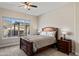 Cozy bedroom with a queen-sized bed, nightstands, and a window with a view at 21432 W Minnezona Ave, Buckeye, AZ 85396