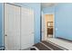 Another view of the blue bedroom with closet and view into another room at 21432 W Minnezona Ave, Buckeye, AZ 85396