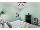 Bright bedroom with light green walls, ceiling fan and natural light at 21432 W Minnezona Ave, Buckeye, AZ 85396