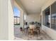 Covered patio featuring tile flooring, a wine barrel table, and a view to the pergola area at 21432 W Minnezona Ave, Buckeye, AZ 85396