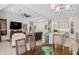Open concept dining area with modern chandelier and access to kitchen and living room at 21432 W Minnezona Ave, Buckeye, AZ 85396