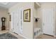 Entryway featuring neutral colors, a bench, storage cubbies, tile flooring, and a coat rack at 21432 W Minnezona Ave, Buckeye, AZ 85396