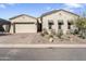 Charming home with a well-manicured front yard featuring desert landscaping and attractive curb appeal at 21432 W Minnezona Ave, Buckeye, AZ 85396