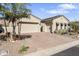 Inviting home featuring a three-car garage, desert landscaping, and a charming exterior elevation at 21432 W Minnezona Ave, Buckeye, AZ 85396