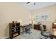 Spacious home office with desks, ample storage, and natural light from a window at 21432 W Minnezona Ave, Buckeye, AZ 85396