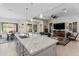 Open concept kitchen featuring granite countertops, stainless sink, and views to living area at 21432 W Minnezona Ave, Buckeye, AZ 85396