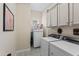Convenient laundry room with modern appliances and ample storage at 21432 W Minnezona Ave, Buckeye, AZ 85396