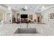 Open-concept living room with a ceiling fan, large tv, and neutral colors with ample seating at 21432 W Minnezona Ave, Buckeye, AZ 85396