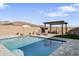 Beautiful backyard pool area with lounge seating, a pergola, a paved patio, and block wall fencing at 21432 W Minnezona Ave, Buckeye, AZ 85396