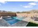 This backyard features a pool and desert landscaping, perfect for relaxing and enjoying the outdoors at 21432 W Minnezona Ave, Buckeye, AZ 85396