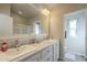 Bright bathroom vanity with dual sinks and a view of the walk-in shower at 2206 S Ellsworth Rd # 50B, Mesa, AZ 85209
