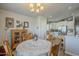 Charming dining area featuring a round table with lace tablecloth and vintage-style wooden chairs, adjacent to a bright kitchen at 2206 S Ellsworth Rd # 50B, Mesa, AZ 85209