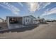 Inviting exterior view of home with carport, white fencing, and landscaped surroundings on a sunny day at 2206 S Ellsworth Rd # 50B, Mesa, AZ 85209