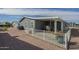 Back patio with dining table and chairs, offering an ideal space for outdoor relaxation and entertaining at 2206 S Ellsworth Rd # 50B, Mesa, AZ 85209