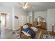 Sunlit main bedroom featuring a vanity, closet, wood-look floors, and bedframe at 2206 S Ellsworth Rd # 50B, Mesa, AZ 85209