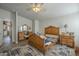 Bright main bedroom showcasing a vanity, wood-look floors, and vaulted ceiling at 2206 S Ellsworth Rd # 50B, Mesa, AZ 85209