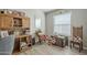 Cozy office area with built-in shelving, wood-style flooring, and plenty of natural light from the window at 2206 S Ellsworth Rd # 50B, Mesa, AZ 85209