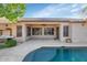 Inviting pool and patio area featuring a covered patio with fan and a grill at 22722 N 120Th Ln, Sun City, AZ 85373