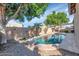 Backyard featuring a sparkling pool and patio area surrounded by a desert landscape at 22722 N 120Th Ln, Sun City, AZ 85373