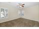 Bedroom featuring a ceiling fan, neutral color palette, and shuttered windows at 22722 N 120Th Ln, Sun City, AZ 85373