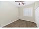Comfortable carpeted bedroom featuring a bright window with crisp white shutters at 22722 N 120Th Ln, Sun City, AZ 85373