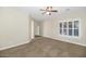 Bedroom featuring a ceiling fan, neutral color palette, and shuttered windows at 22722 N 120Th Ln, Sun City, AZ 85373