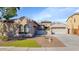 Charming single-story home showcasing low-maintenance desert landscaping, a three-car garage and neutral stucco at 22722 N 120Th Ln, Sun City, AZ 85373