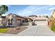 Inviting single-story home features a neutral color palette, low maintenance landscaping, and convenient three-car garage at 22722 N 120Th Ln, Sun City, AZ 85373