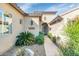 The front entrance of this home features desert landscaping with a tile walkway leading to an ornate front door at 22722 N 120Th Ln, Sun City, AZ 85373