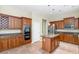 Beautiful kitchen featuring an island, stainless steel appliances, and generous wood cabinetry at 22722 N 120Th Ln, Sun City, AZ 85373