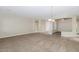 Spacious living room features neutral color palette, tile entryway, and plush carpeting at 22722 N 120Th Ln, Sun City, AZ 85373