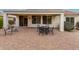Covered back patio with a paved brick floor, perfect for outdoor dining and entertaining at 26485 W Yukon Dr, Buckeye, AZ 85396