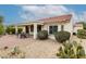 Beautiful backyard with covered patio, desert landscaping, and mature trees enhancing outdoor living space at 26485 W Yukon Dr, Buckeye, AZ 85396