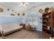Cozy bedroom with a unique ceiling fan, a decorative wall, and wood-look flooring at 26485 W Yukon Dr, Buckeye, AZ 85396