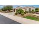 Beautiful front exterior with desert landscaping, manicured shrubs, and a well-maintained lawn at 26485 W Yukon Dr, Buckeye, AZ 85396