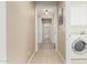 Hallway with tile flooring leading to the laundry area and other rooms at 26485 W Yukon Dr, Buckeye, AZ 85396
