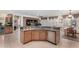 Modern kitchen showcasing a breakfast bar with seating, stainless steel appliances, and recessed lighting at 26485 W Yukon Dr, Buckeye, AZ 85396