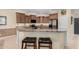 Spacious kitchen with granite countertops, stainless steel appliances, and breakfast bar seating at 26485 W Yukon Dr, Buckeye, AZ 85396