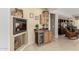 Cozy living room featuring a fireplace, wet bar, and built-in display cabinet at 26485 W Yukon Dr, Buckeye, AZ 85396