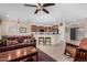 Open concept living room with barstool seating, a ceiling fan, and access to the kitchen at 26485 W Yukon Dr, Buckeye, AZ 85396
