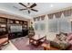 Cozy living room featuring a ceiling fan and a built-in entertainment center at 26485 W Yukon Dr, Buckeye, AZ 85396