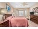 Bright main bedroom with wood-look flooring, large bay window, and a ceiling fan at 26485 W Yukon Dr, Buckeye, AZ 85396