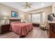 Serene main bedroom with wood flooring, a ceiling fan, and a bay window at 26485 W Yukon Dr, Buckeye, AZ 85396