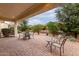 Spacious outdoor patio with paver flooring, offering serene views of the well-manicured backyard and landscaping at 26485 W Yukon Dr, Buckeye, AZ 85396