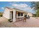 Inviting covered patio with paver flooring and comfortable seating area perfect for entertaining at 26485 W Yukon Dr, Buckeye, AZ 85396