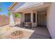 Inviting covered porch with chairs, desert landscaping, and a secure screen door at 276 E Senna Way, San Tan Valley, AZ 85143